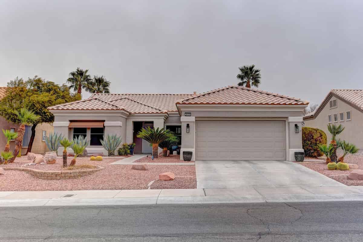 a house with a red roof and a white garage