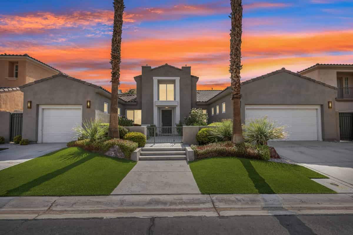 a home with palm trees in front of it