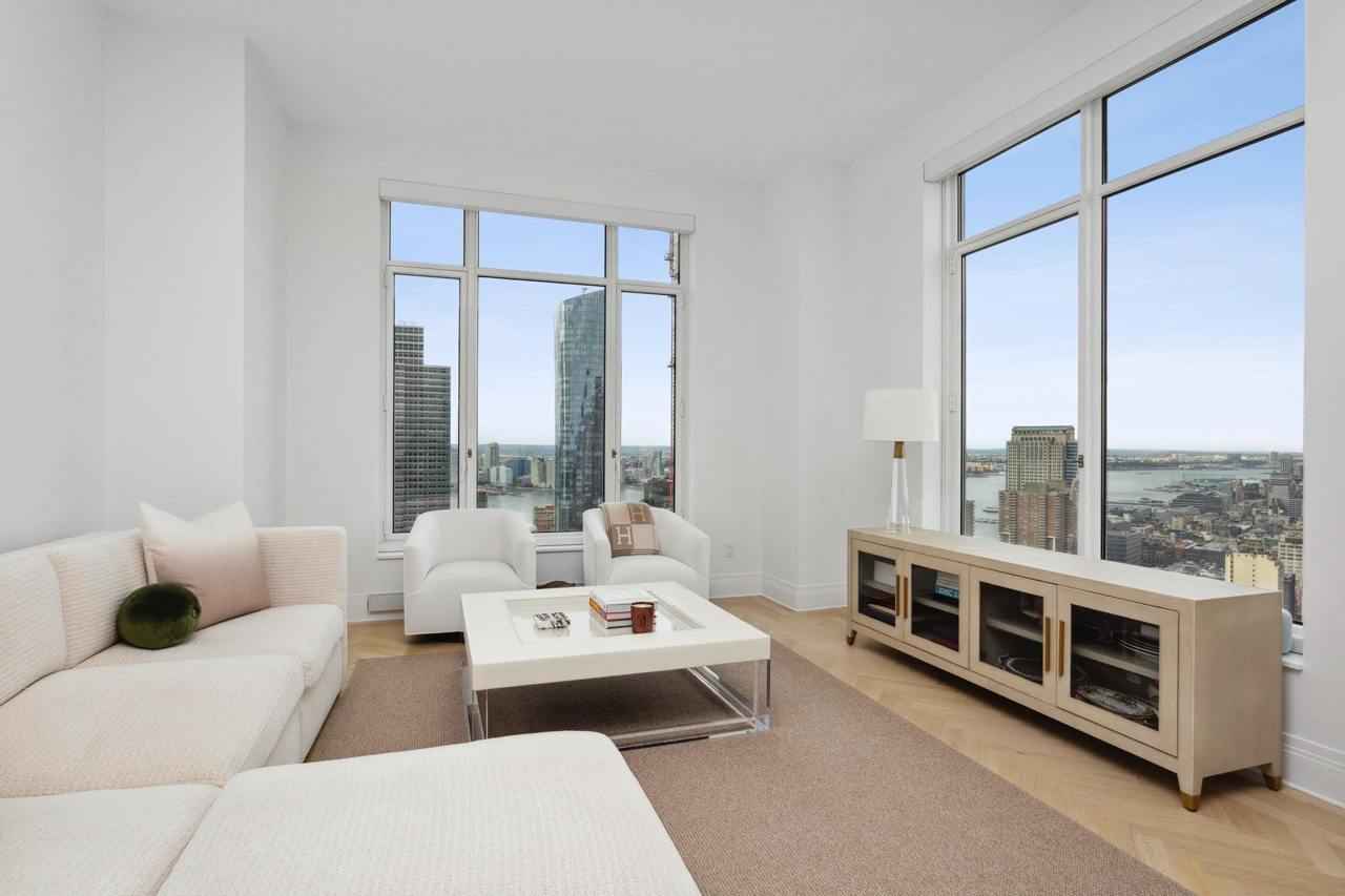 a living room with a couch, a coffee table, and a tv