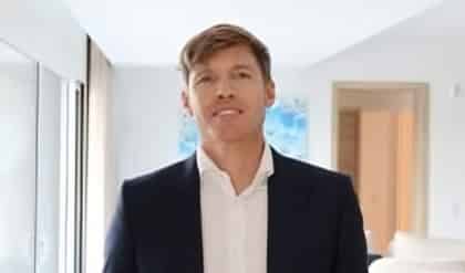 a man in a suit standing in a room