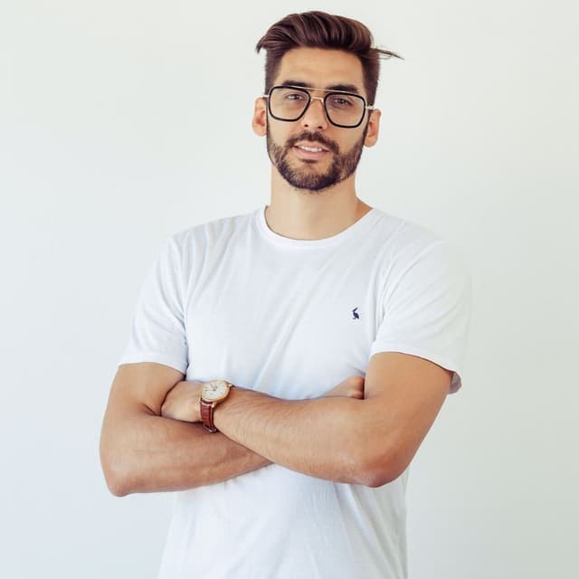 a man with glasses and a white shirt