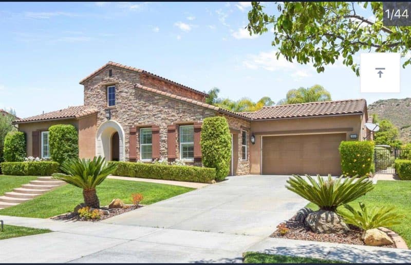 a home in the desert with a driveway and a driveway