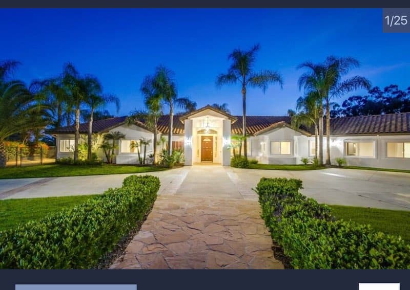 a home with palm trees and a driveway