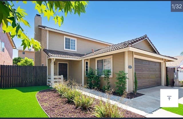 a home with a fence and a yard