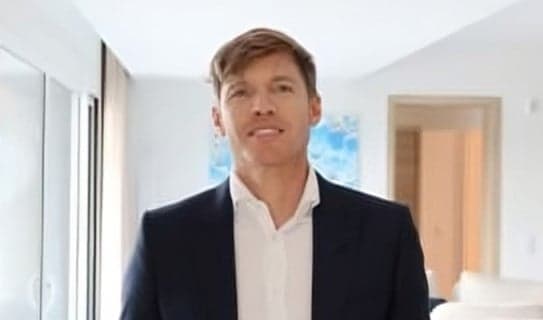 a man in a suit standing in a room
