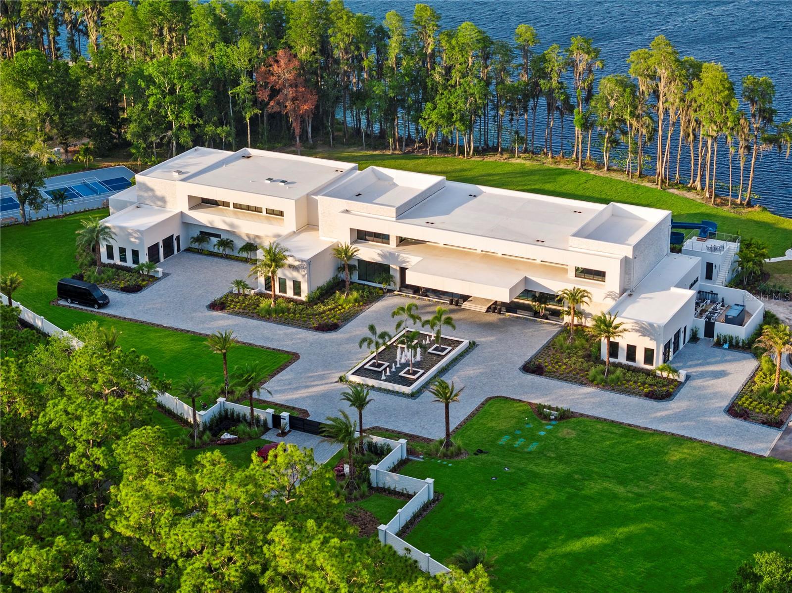 a large white house with a large backyard area