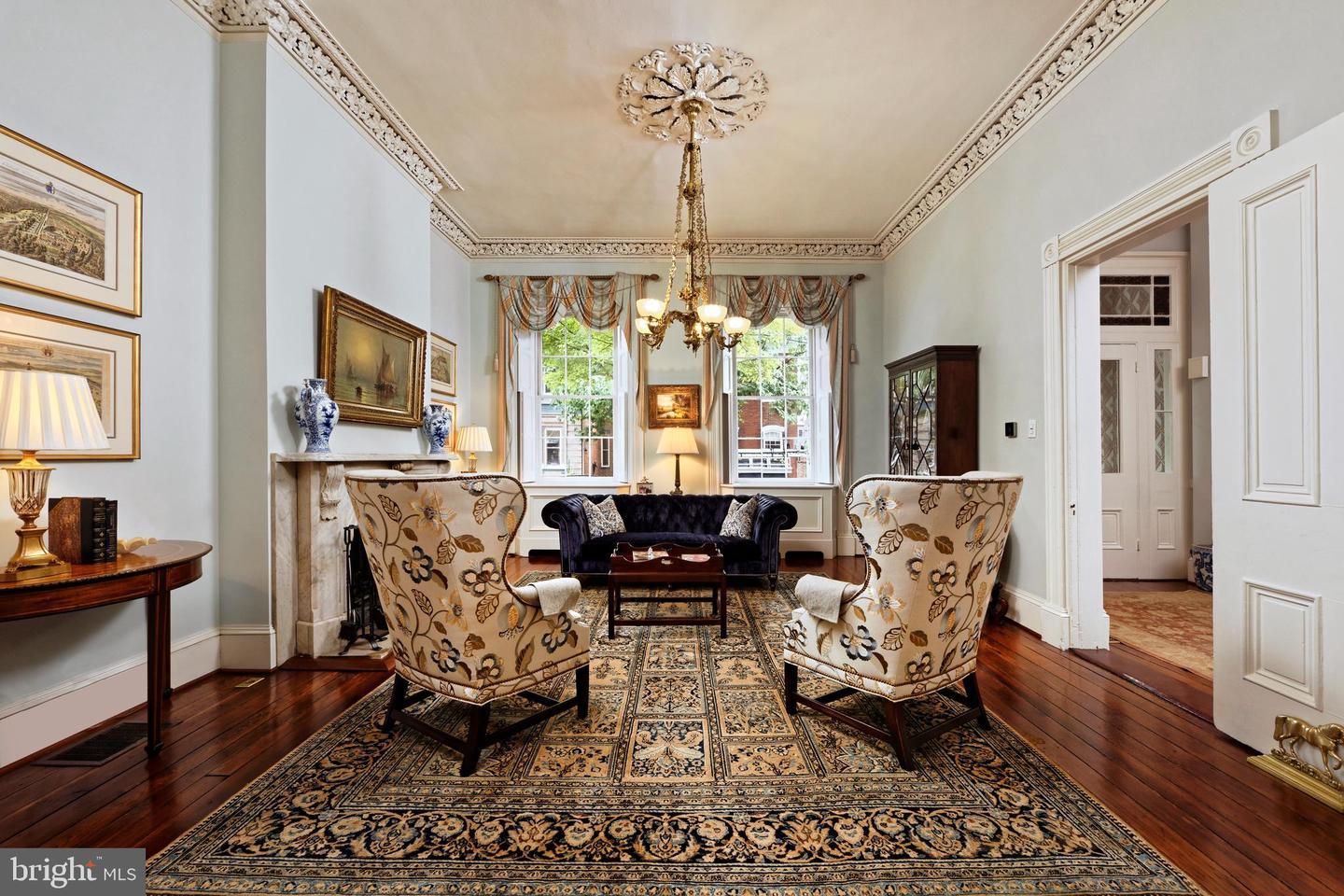 a living room with a couch, chairs, and a table