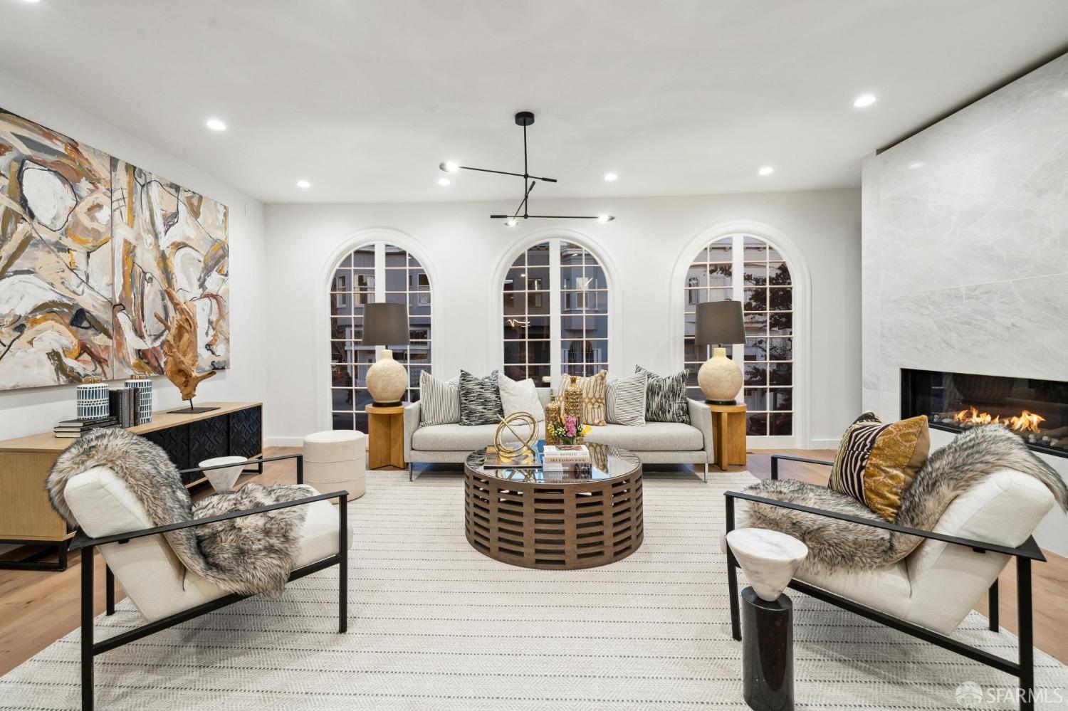 a living room with white walls and a fireplace