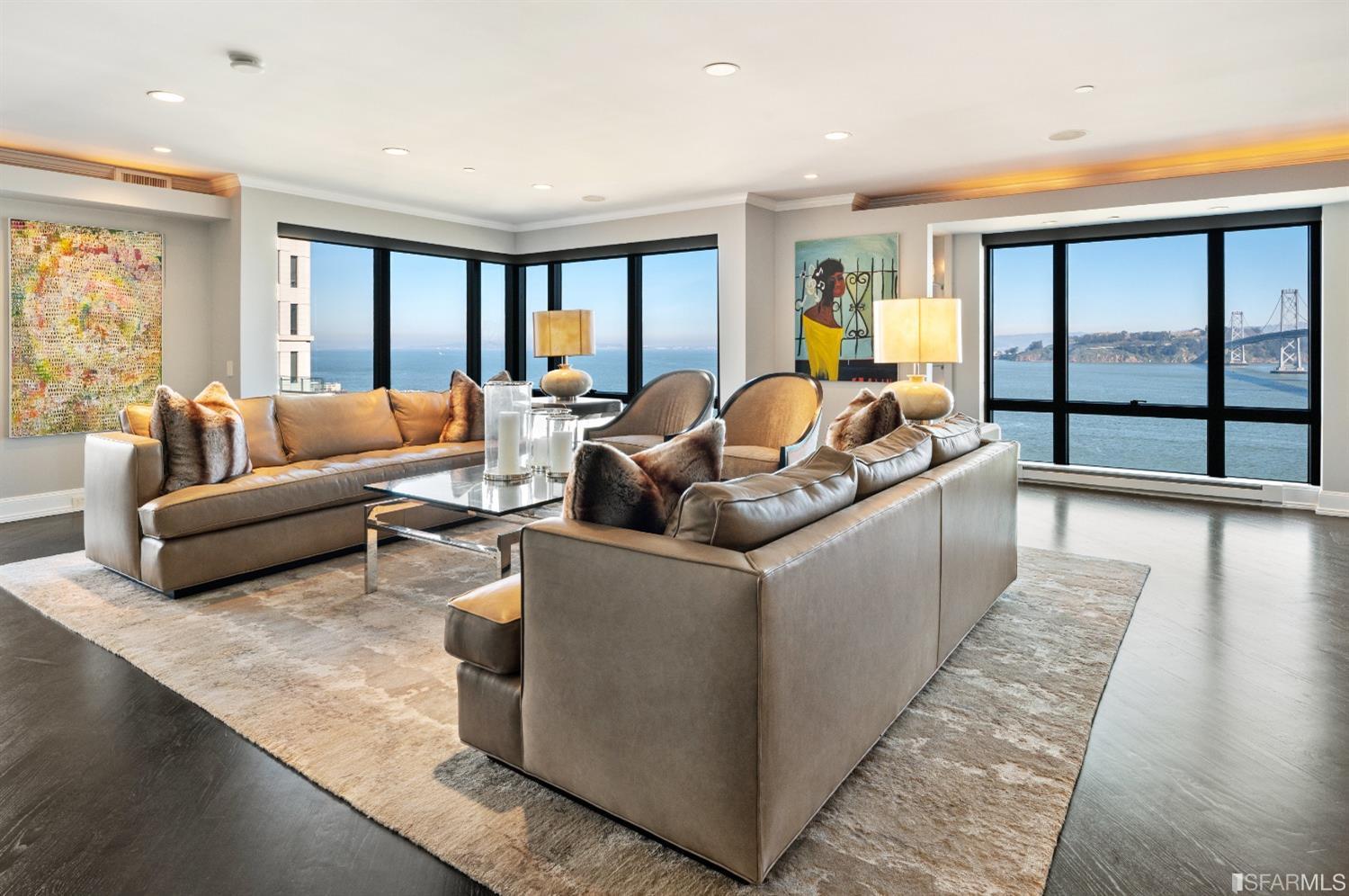 a living room with a large window overlooking the ocean
