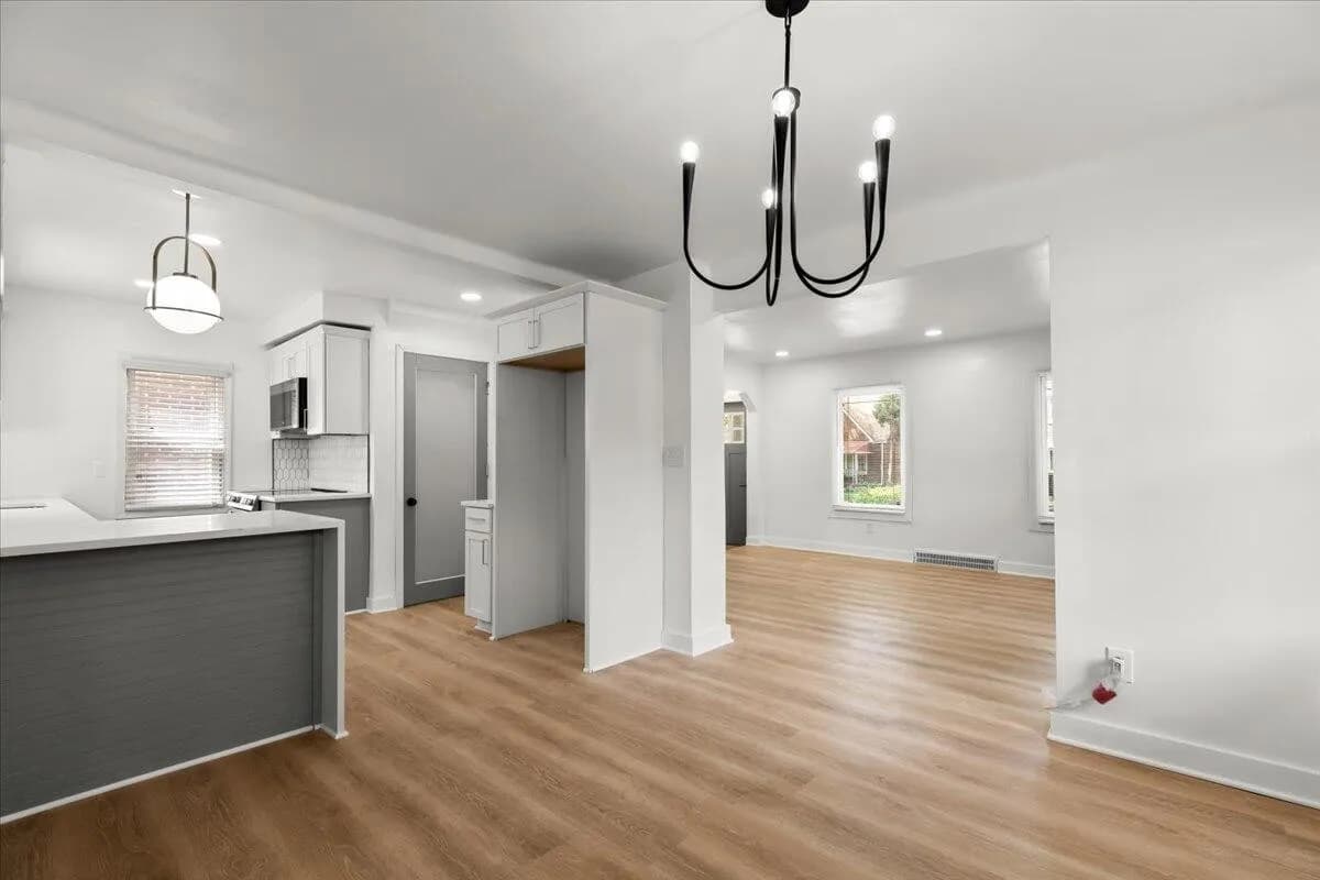 a kitchen with a refrigerator, sink, and a stove