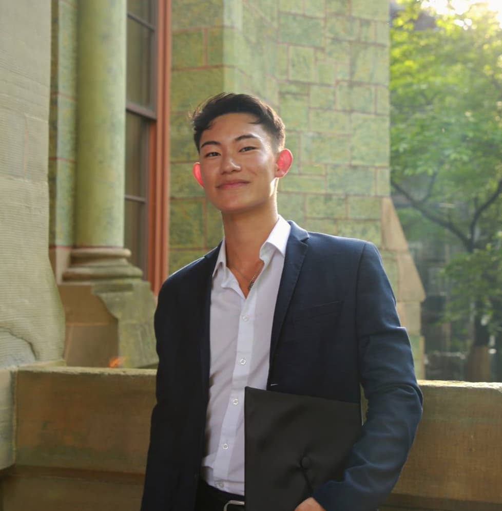 a man in a suit and tie standing on a wall